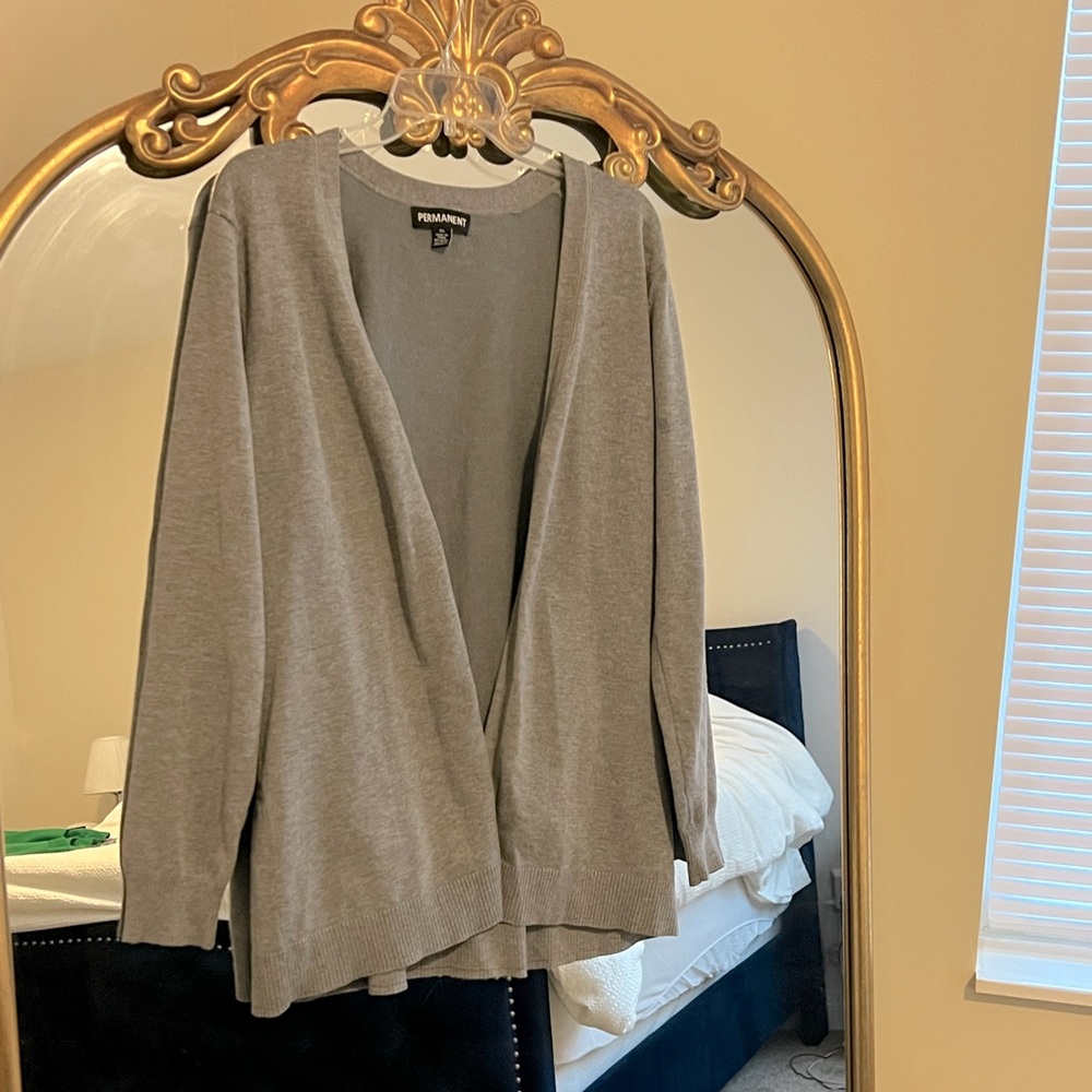 Gray cardigan with peplum bottom.
